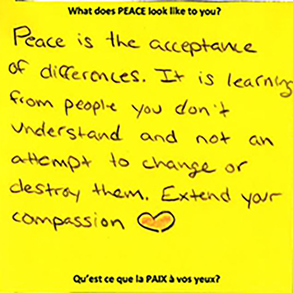 Dark yellow piece of paper with black ink writing on it.