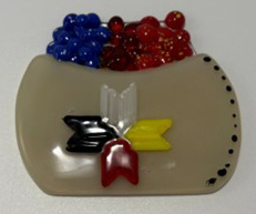 Fused glass piece depicting a brown basket of blue and redberries, adorned with quillwork, its eight-pointed star shines in the four sacred colours white, yellow, red, and black.