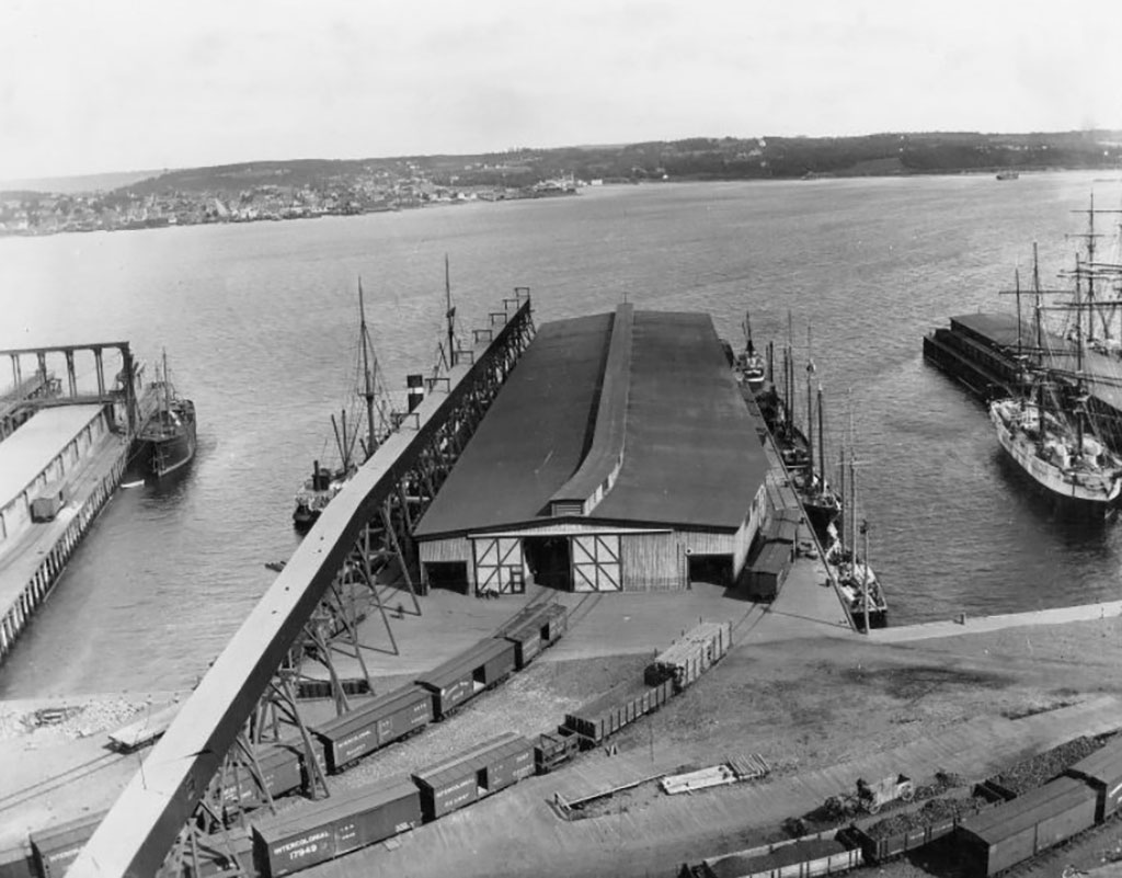 A pier is being constructed, there are two train tracks leading to it.