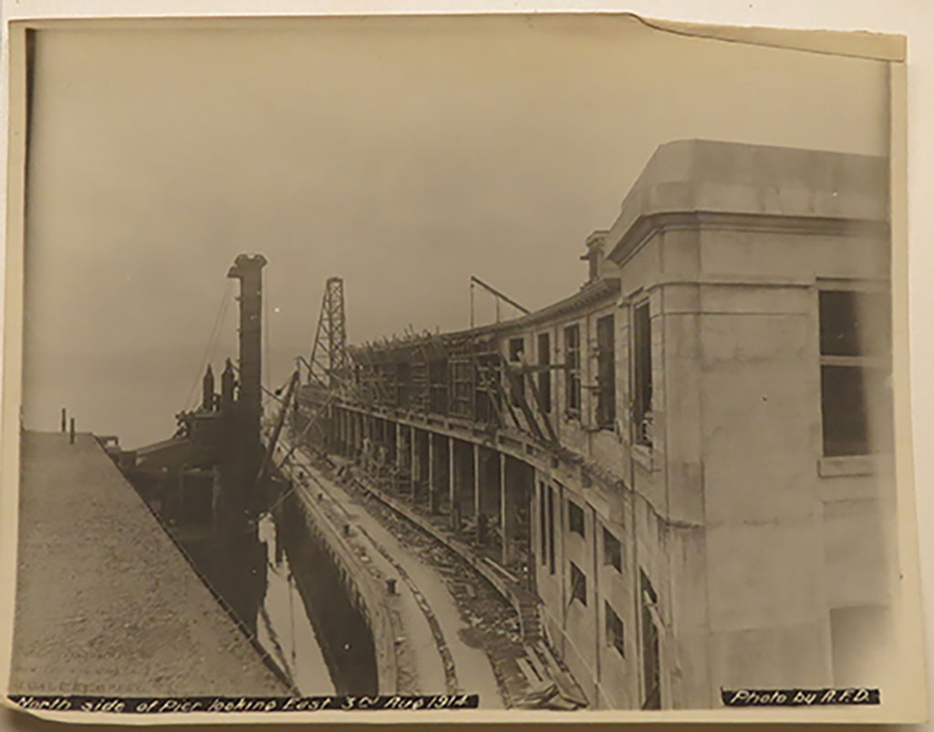 A pier under construction, the image is very old and blurry.