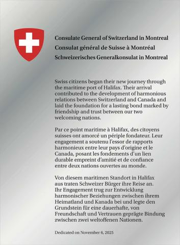 Shiny silver plaque with a crest and text.