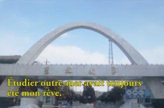 A large arch monument spans a bridge.