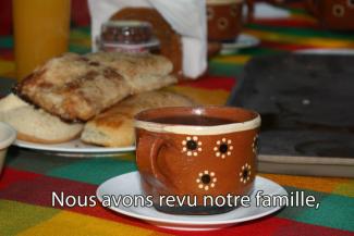 A table laden with danishes and coffee.