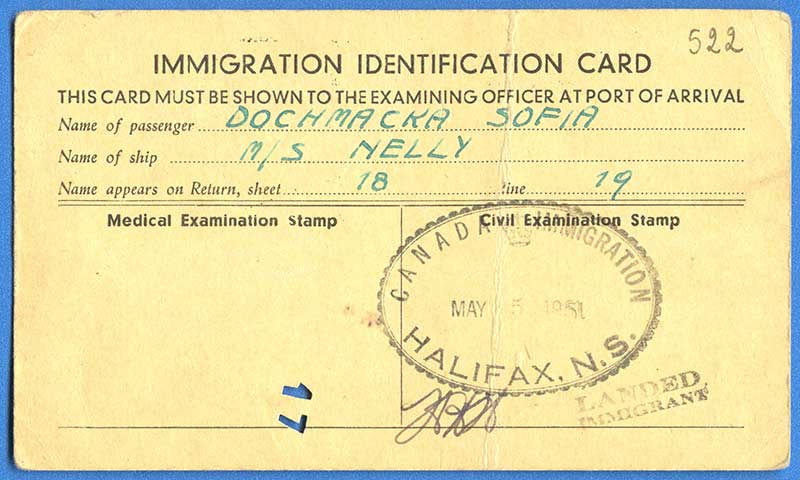 Immigration identification card with passenger and ship name stamped on.