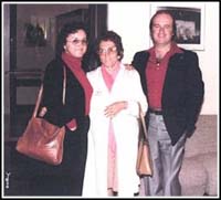 Older woman flanked by younger man and woman.