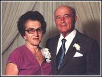 Middle-aged couple well-dressed and wearing corsages.