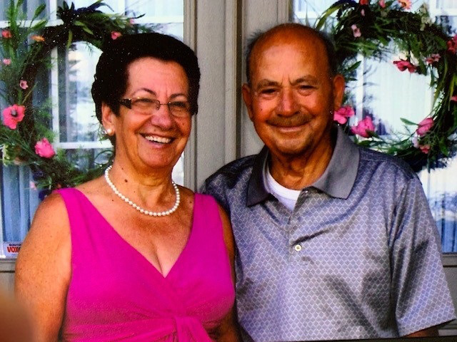 Colourful photo of a happy, smiling couple.