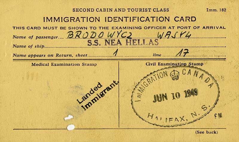 Immigration identification card on a yellow paper with two stamps, name of passenger Brodowycz Wasyl and name of ship.