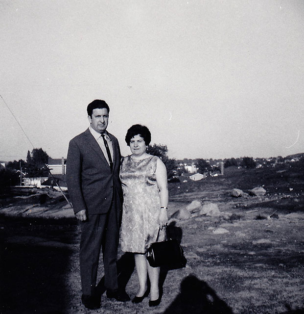 Well dressed handsome man & beautiful woman standing for photo.