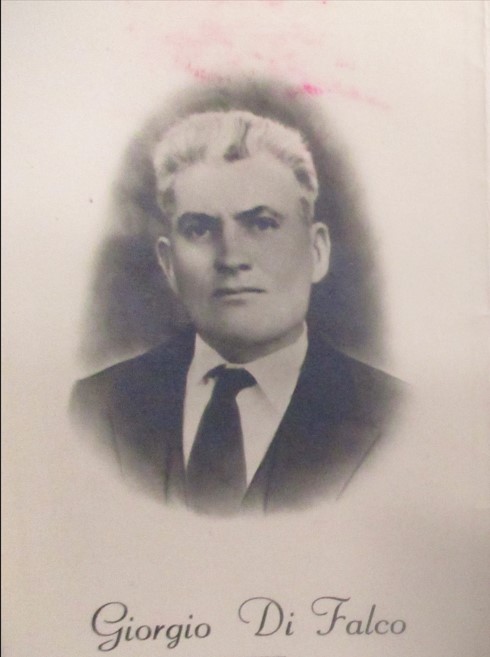 A black and white portrait of a man in a suit.