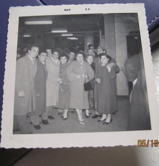 A black and white photo of a group of white people in formal clothing.