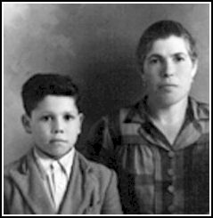 Family portrait of a woman and a young boy in a suit.