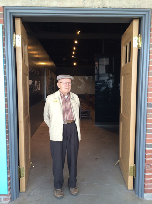 A young man stands in a doorway of a museum.