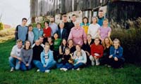 Group photo with several family members sitting/standing on grass.