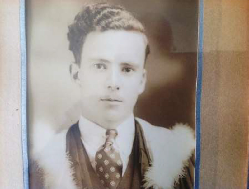 Old graduate photo of young man, wearing graduation gown