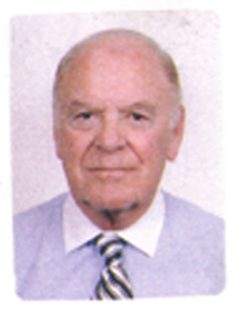 Photograph of older Henry, wearing a blue shirt and tie.