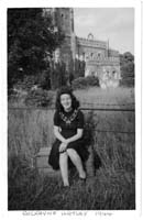 Iris as a young woman, sitting in a field.