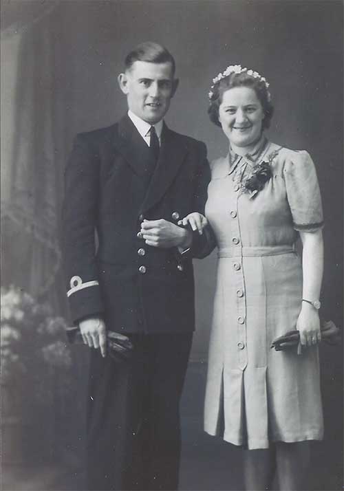 Well-dressed couple standing next to each other.