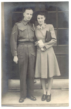 Young Hugh and his wife, with gloves, clutch purse and hat.