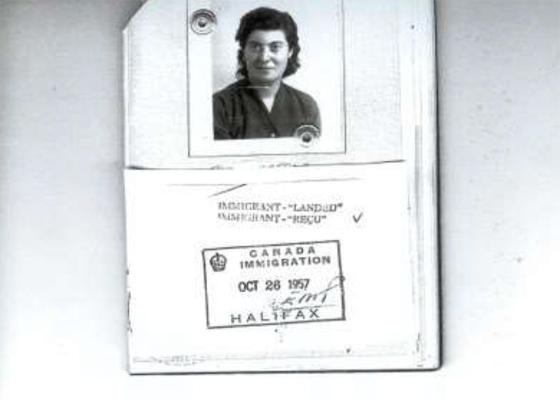 Paper of Immigration landed with photo and Canada immigration Halifax stamp and date.