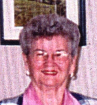 Recent, coloured photo of older Mary wearing glasses.