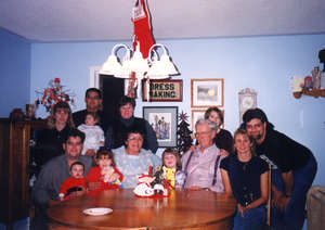 Color photograph of older Mels, surrounded by younger generations of family members.