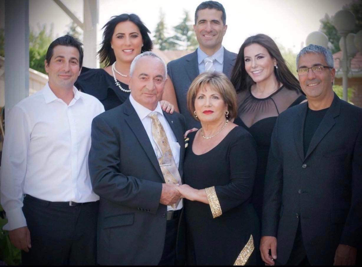 A family portrait with seven people smiling.