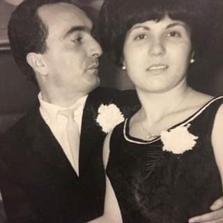 A man and a woman in fancy clothing, seemingly from decades ago.