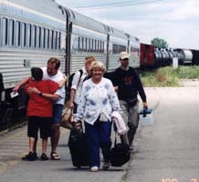 Coloured photo of people getting off train.