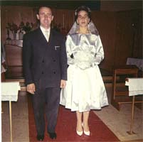 Young spouses standing in the central aisle of the church on their wedding day. 