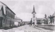 Street view of Hungarian town, showing church and office buildings.