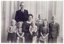 Old family photograph with mother, father and six children.